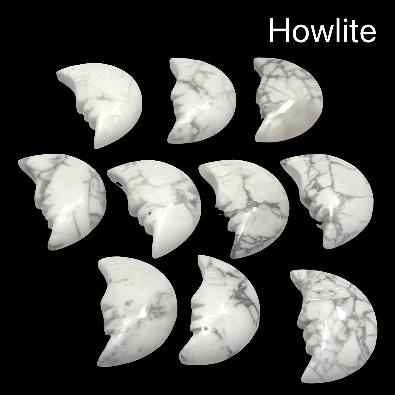 A group of Howlite Gemstone moon carvings on a black background, front view.
