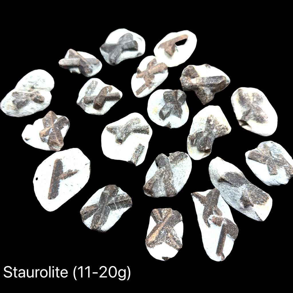 A group of Natural staurolite fairy cross stone from Kola Peninsula Russia showing cross formation, on a black background, front view. Weights (11-20g)