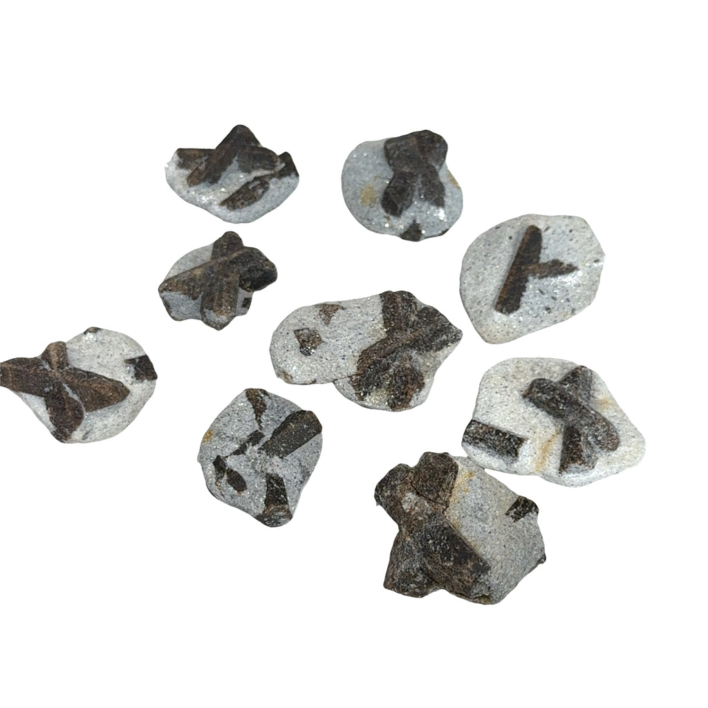 A group of Natural staurolite fairy cross stone from Kola Peninsula Russia showing cross formation, on a white background, front view.