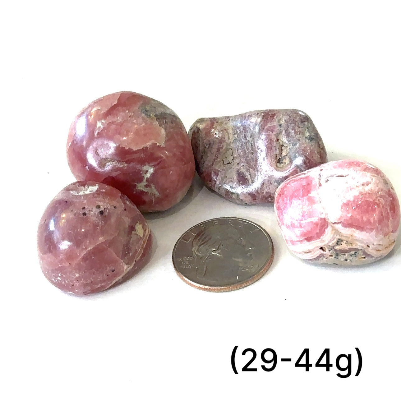 A group of Rhodochrosite tumbled weighing (29-44g) on a white background, front view.  