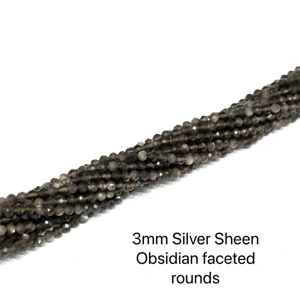 A group of strands of 3mm Silver Sheen  Obsidian faceted  round gemstone beads on a white background, front overview. 