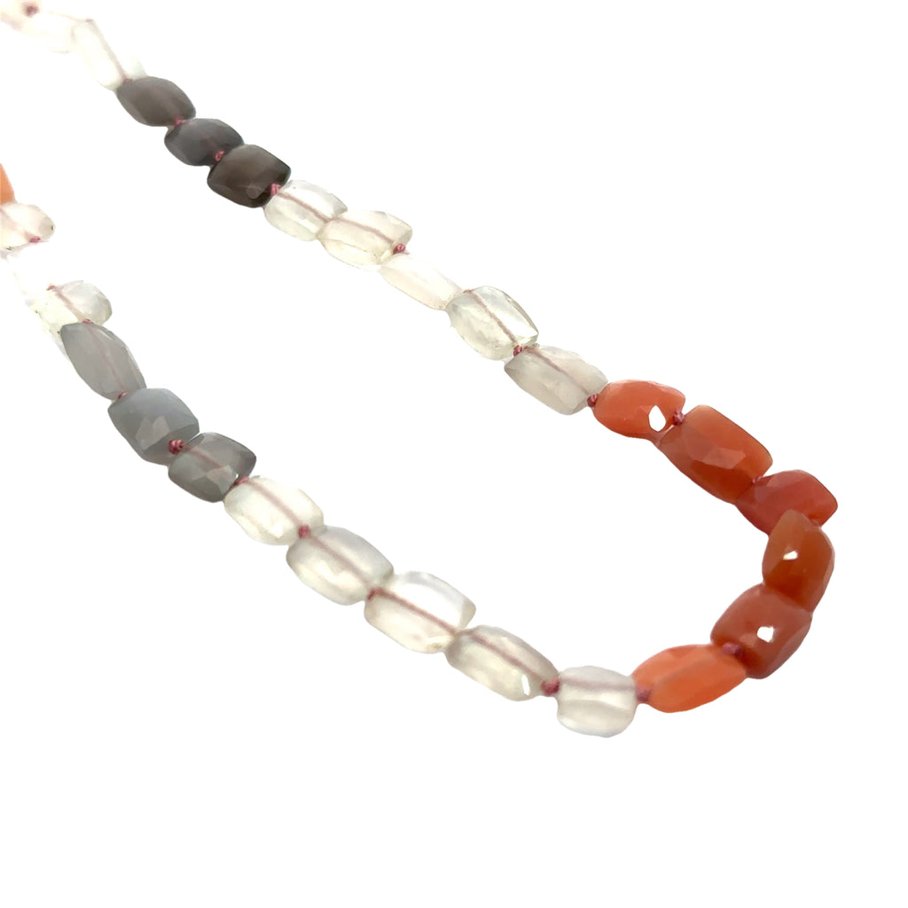 A knotted necklace made of mixed moonstone gemstones with a sterling silver toggle clasp on a white background, long diagonal overview 