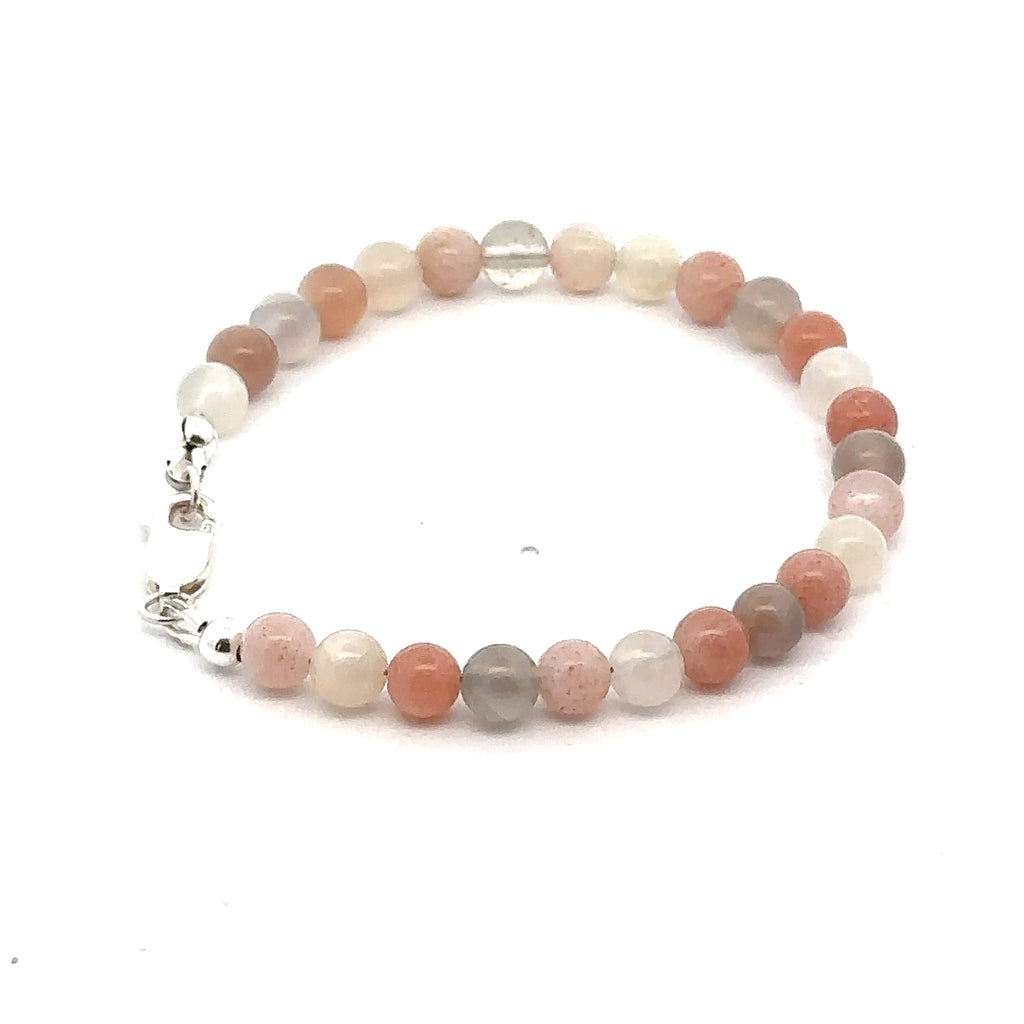 A mixed Moonstone gemstone beaded bracelet with a sterling silver lobster claw clasp on a white background, left side, overview. 