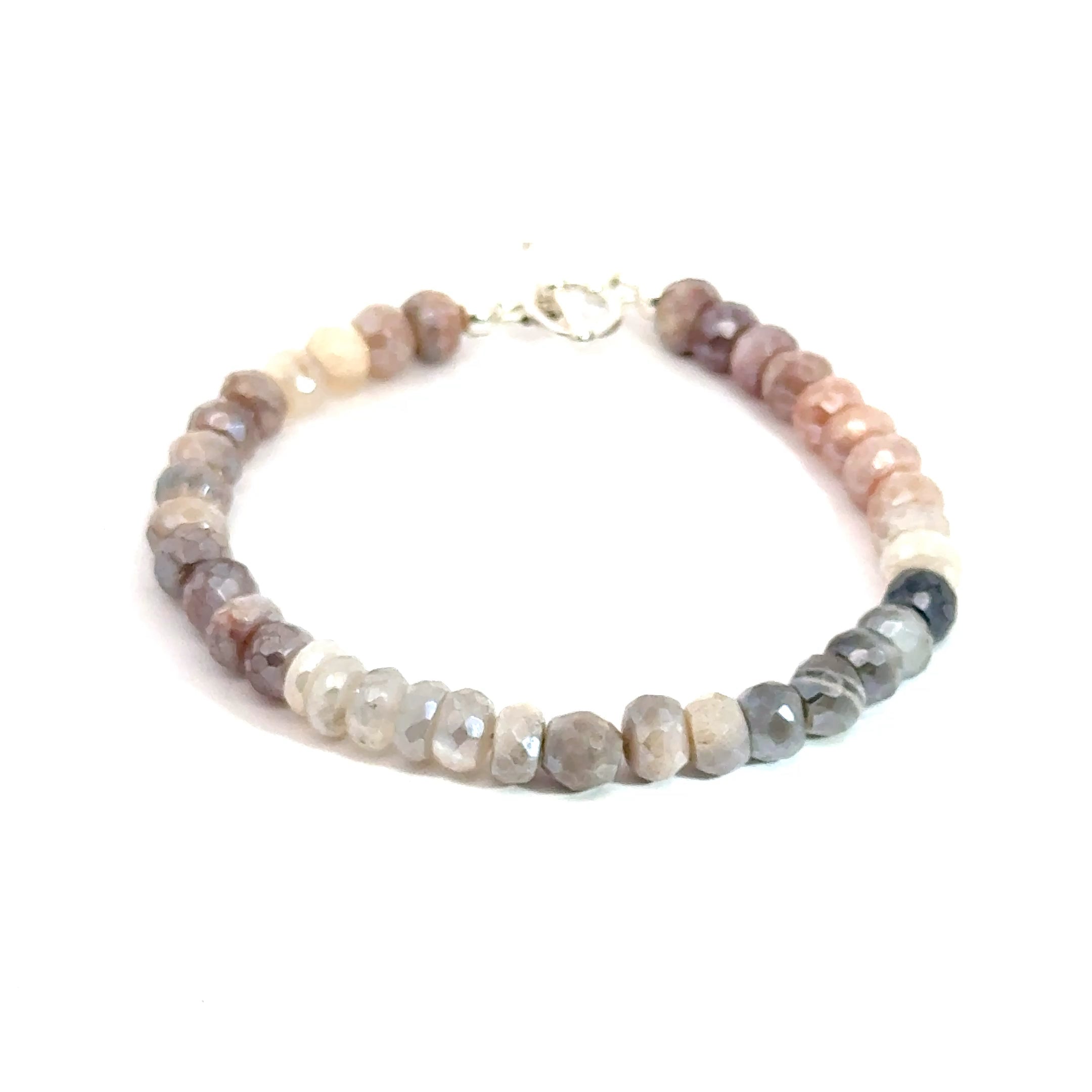 A mixed Moonstone gemstone faceted roundel beaded bracelet with a sterling silver toggle clasp on a white background, front, overview. 