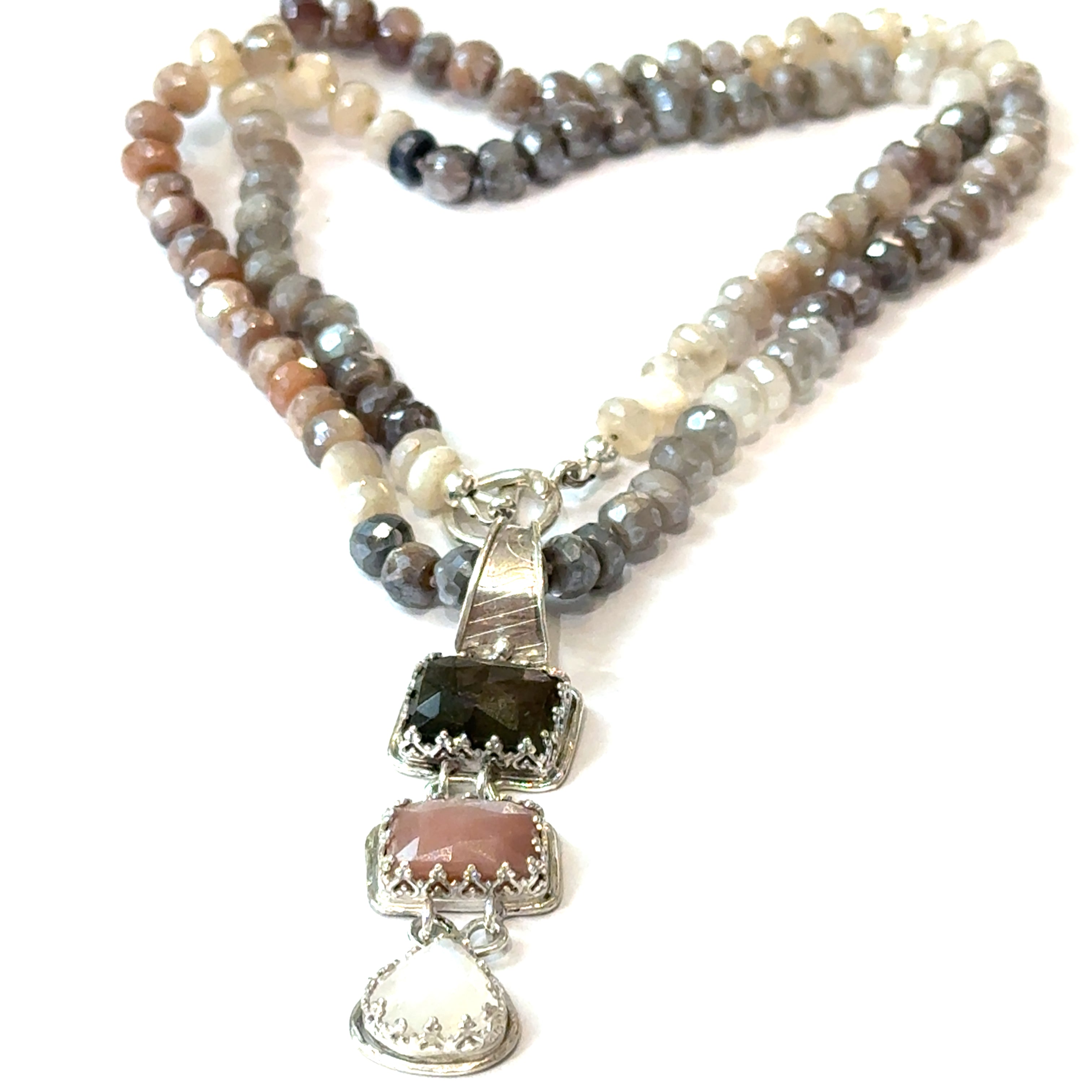 A mixed moonstone faceted roundel knotted necklace with a custom forged sterling silver with three gemstones pendant. on a white background, front long  overview. 