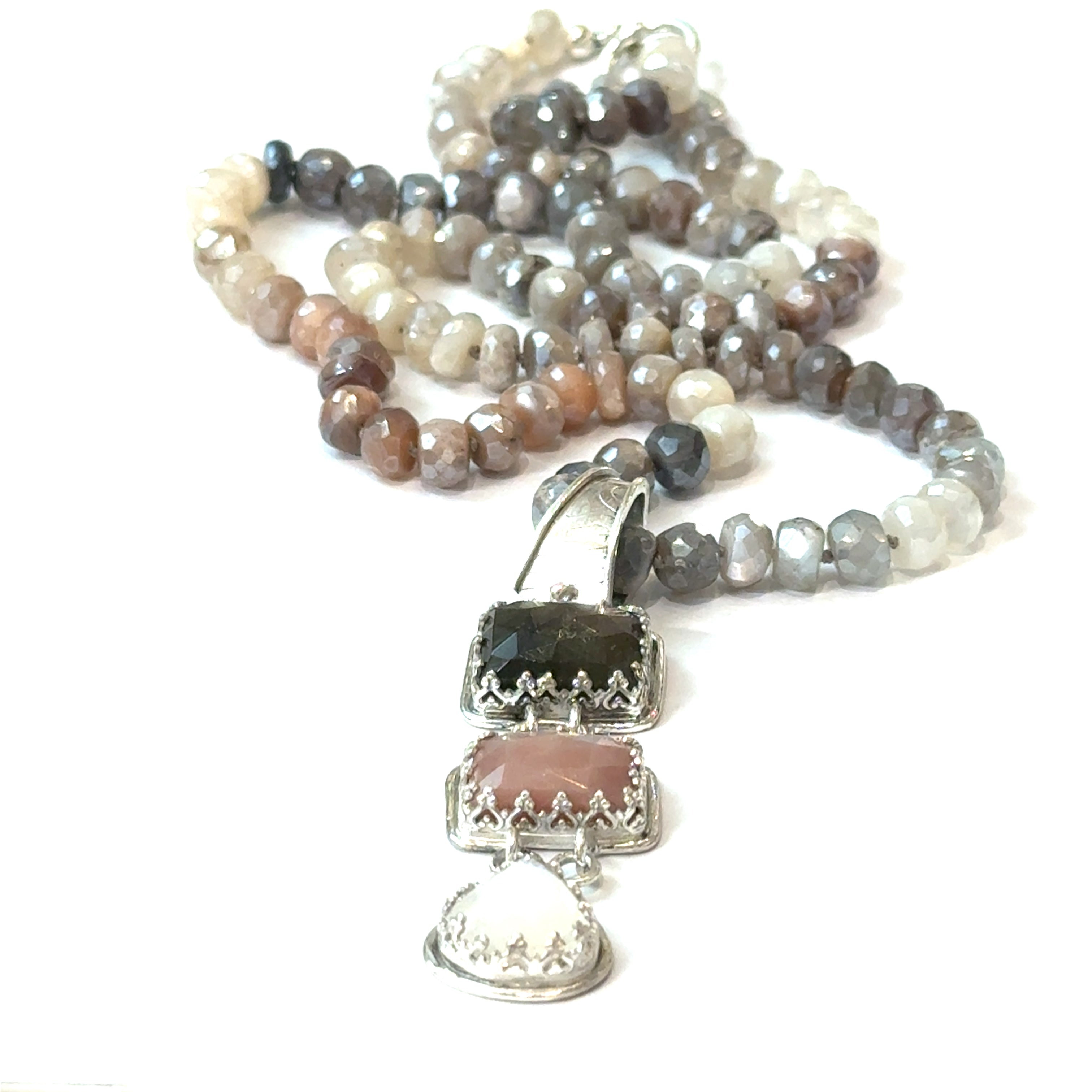A mixed moonstone faceted roundel knotted necklace with a custom forged sterling silver with three gemstones pendant. on a white background, front pendant focus overview. 