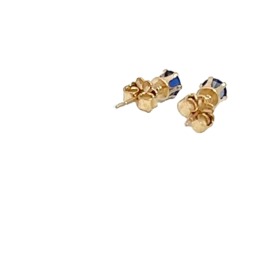 A pair of blue sapphire stud earrings with 14k gold-filled baskets and gold-filled push-backs on a white background, back overview. 