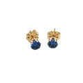 A pair of blue sapphire stud earrings with 14k gold-filled baskets and gold-filled push-backs on a white background, front overview. 