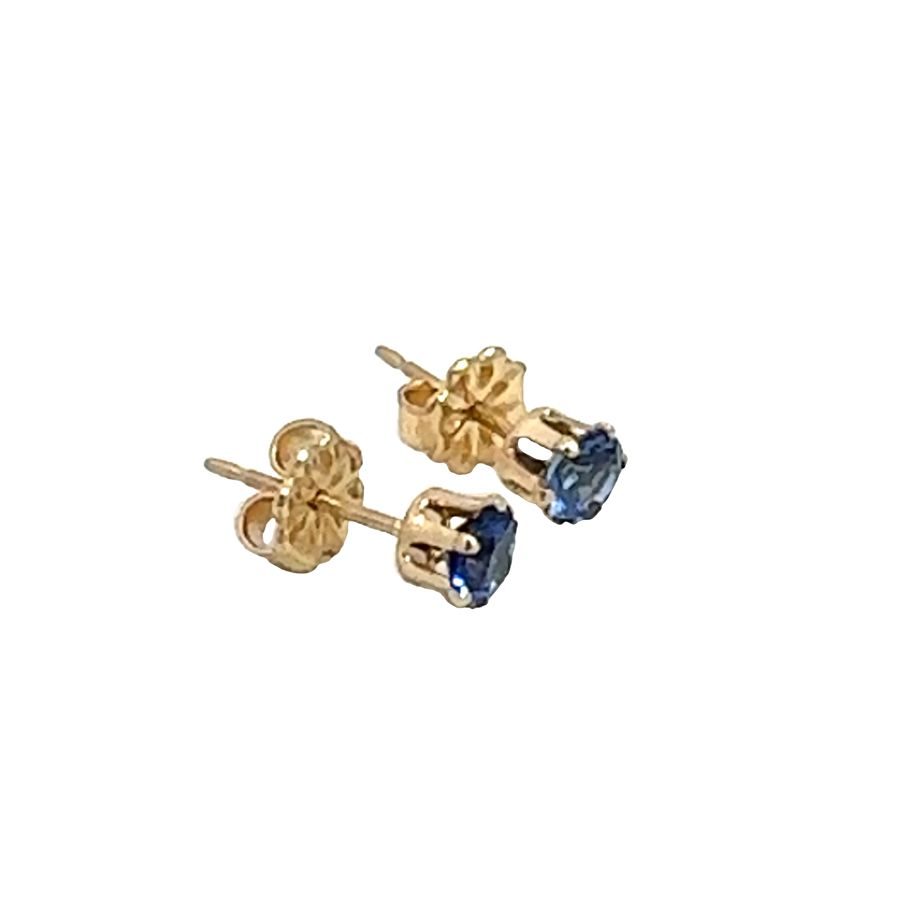 A pair of blue sapphire stud earrings with 14k gold-filled baskets and gold-filled push-backs on a white background, front right angle overview. 