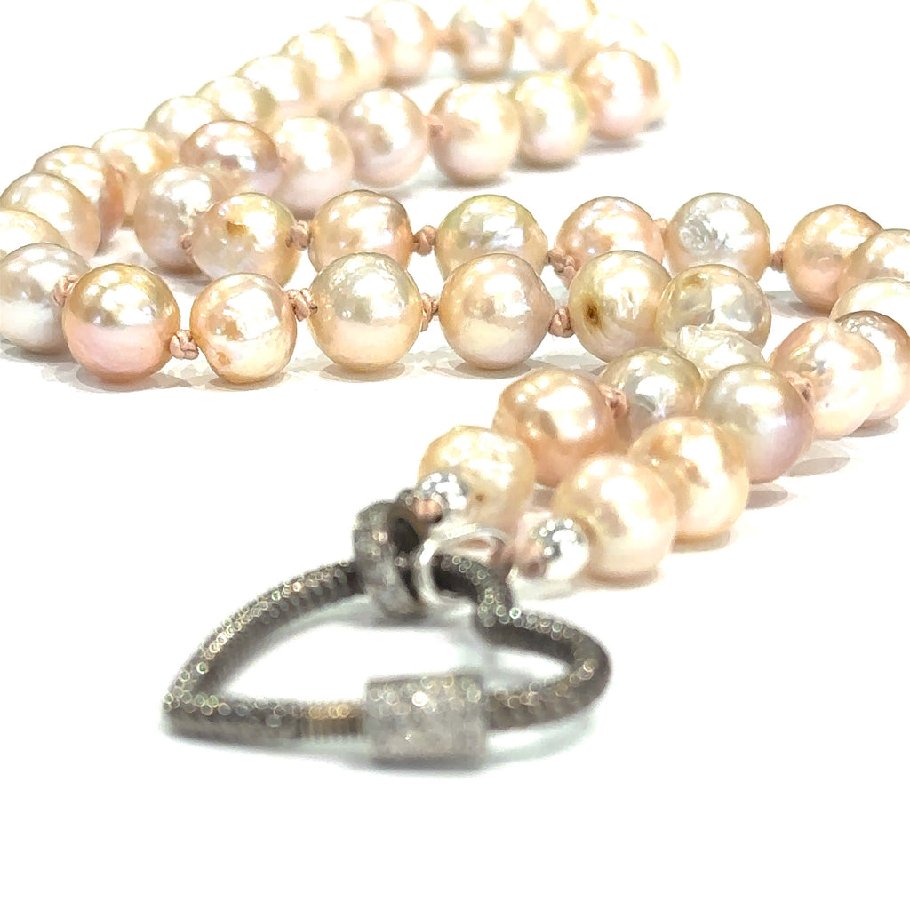 Akoya pearl necklace with heart clasp designed for charms on white heart clasp front view
