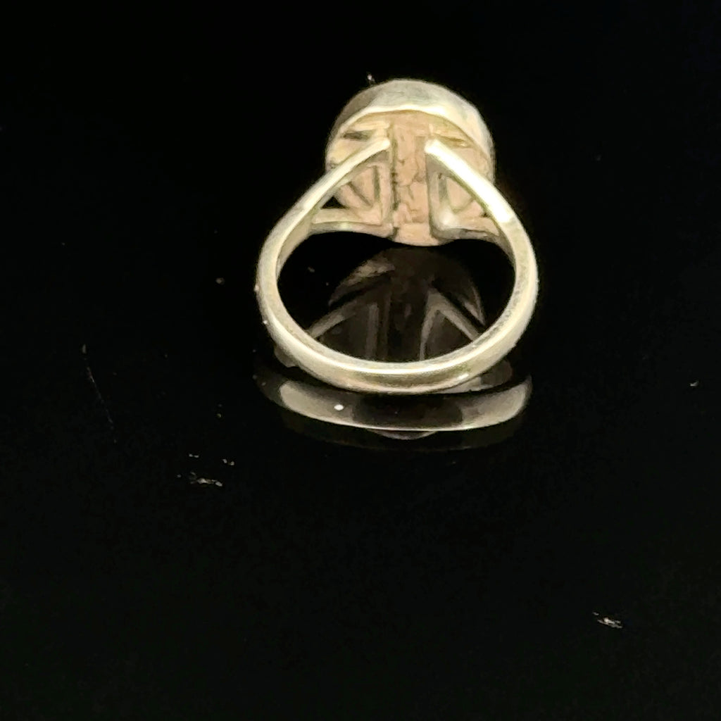Almandine Garnet gemstone sterling silver ring  on a black background, back overview. 