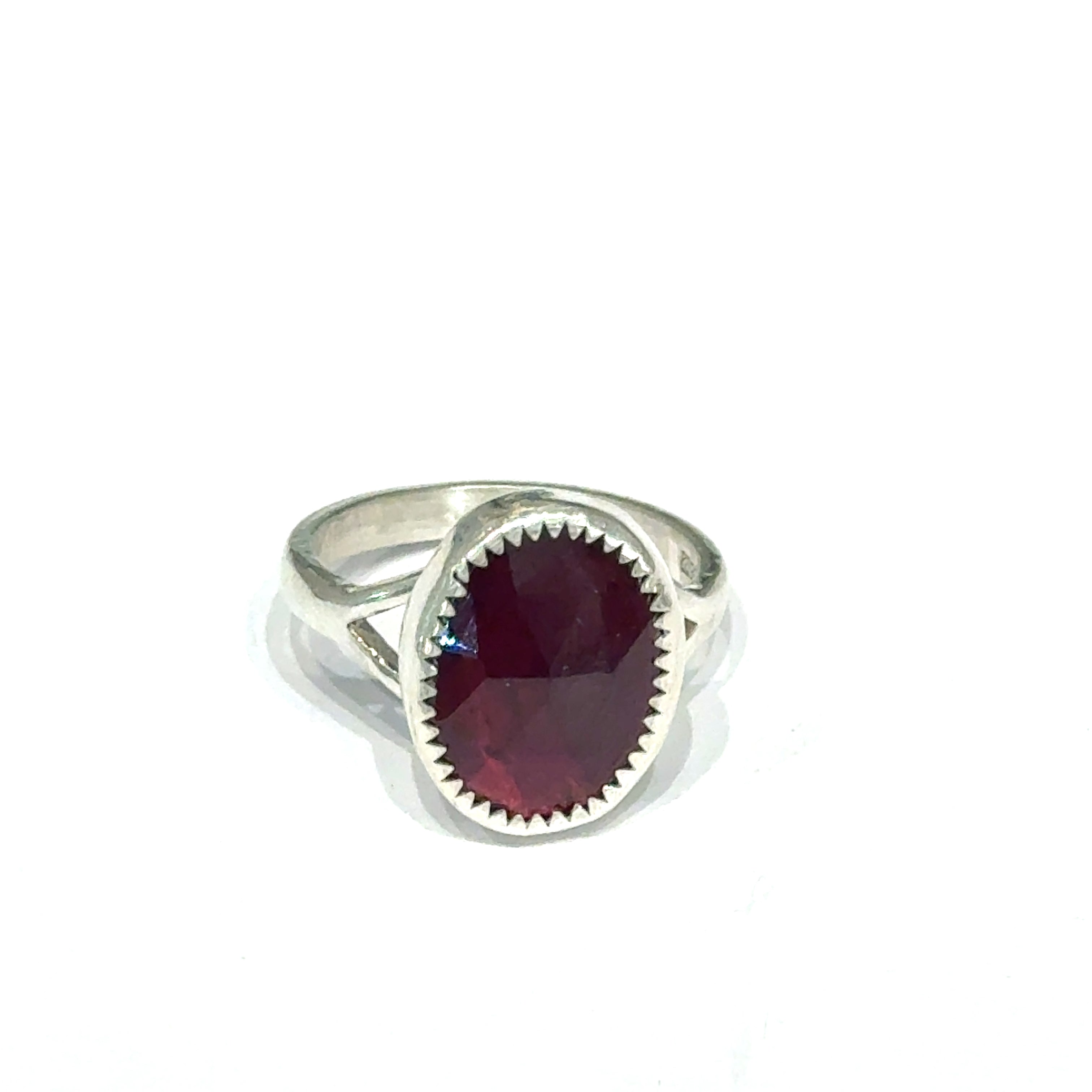 Almandine Garnet gemstone sterling silver ring  on a white background, front overview. 