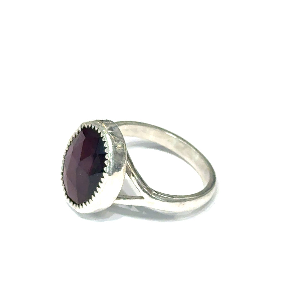 Almandine Garnet gemstone sterling silver ring  on a white background, right side overview. 