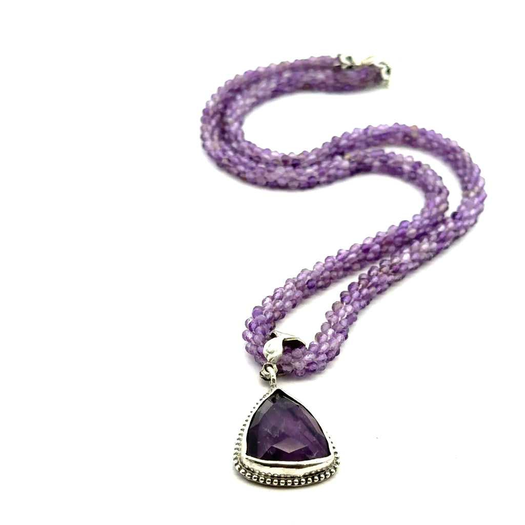 Reiki jewelry in Boston handmade with ethically sourced amethyst gemstones Necklace with Pendant on white over view 
