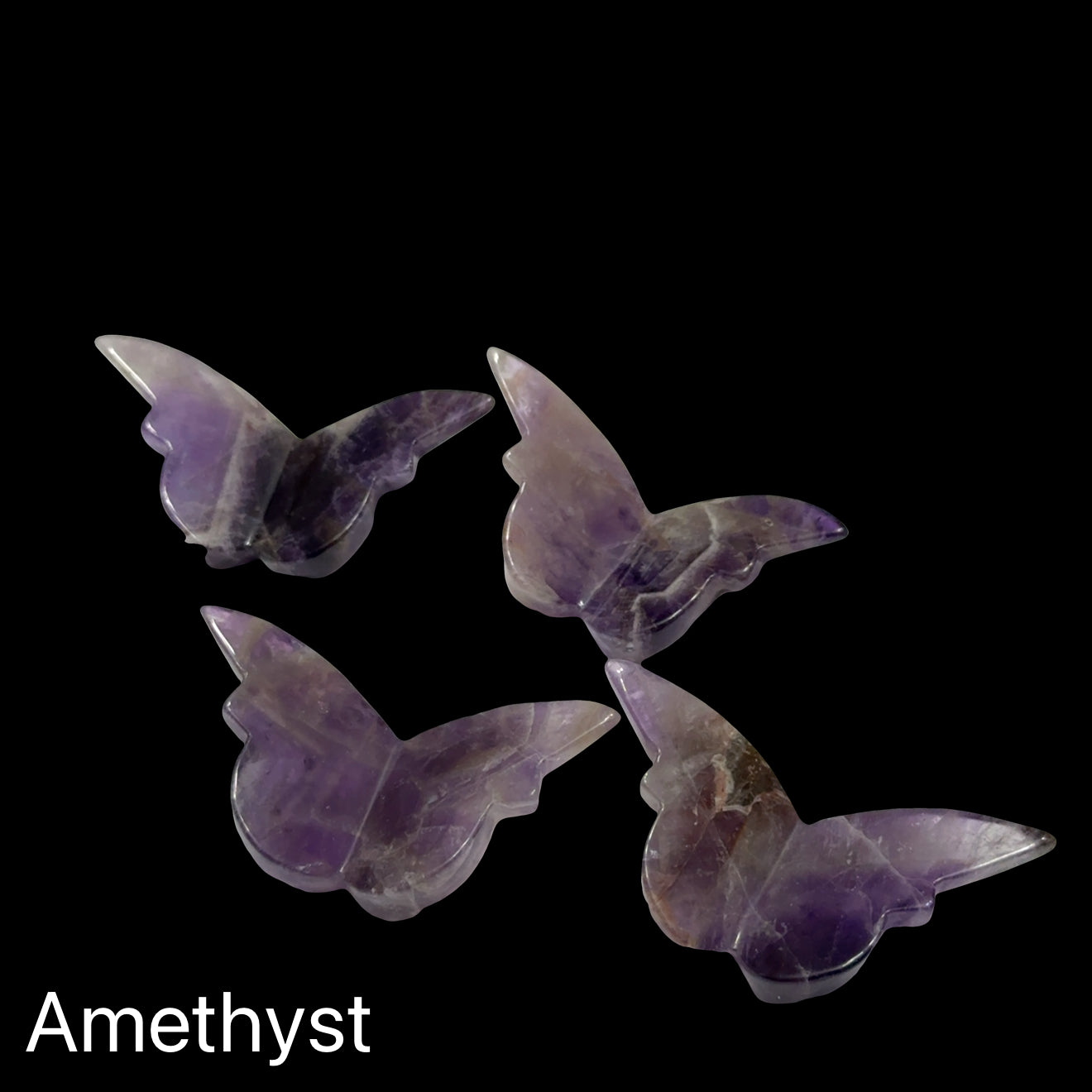 Amethyst butterfly-shaped crystals on a black background, front view.