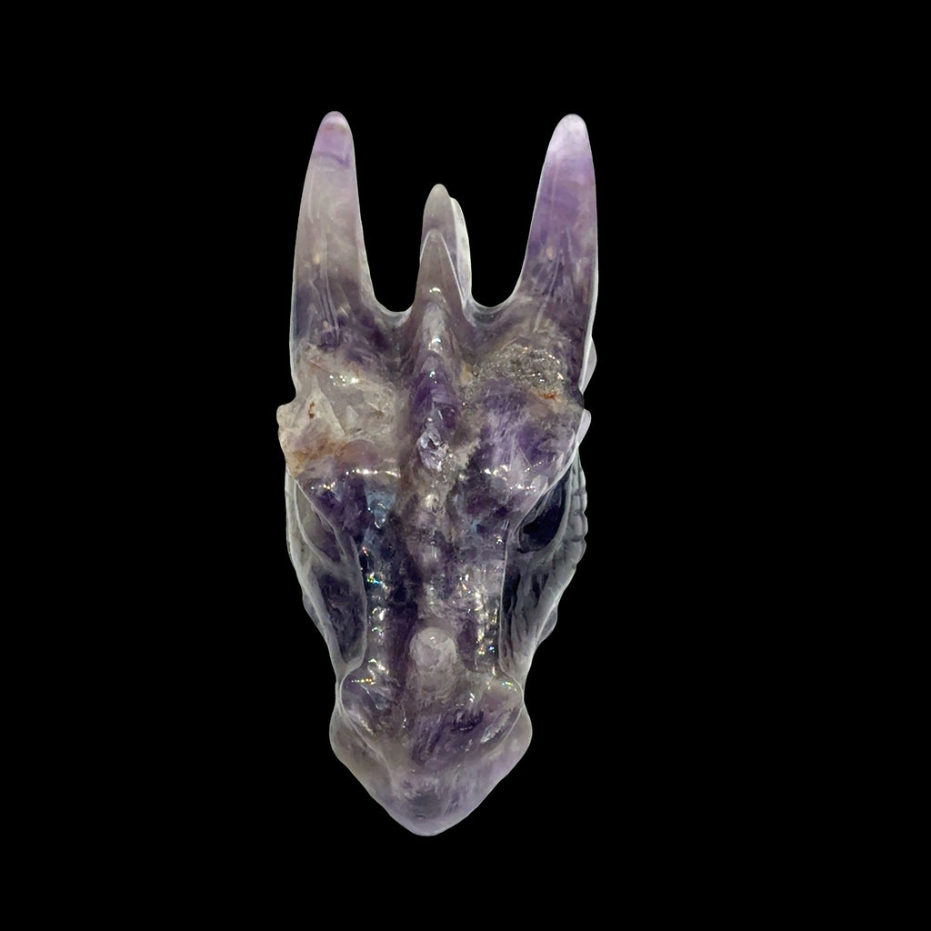Amethyst gemstone dragon head carving, on a black background, front view. 