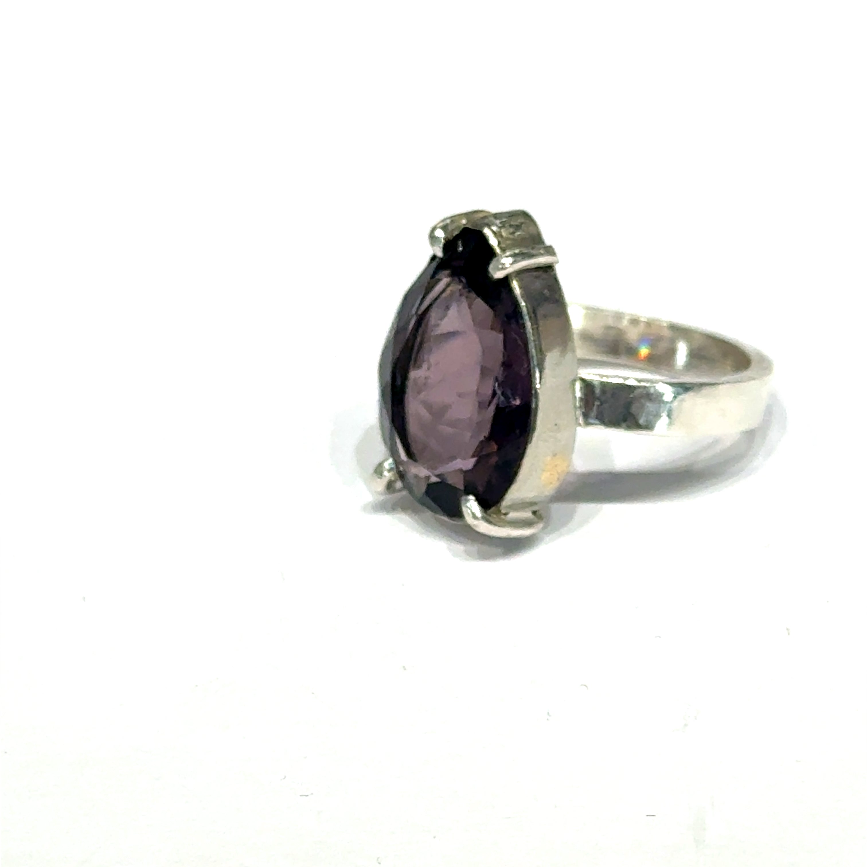 An Ametrine Ring with a purple teardrop-shaped gemstone on a white background, right-side view.