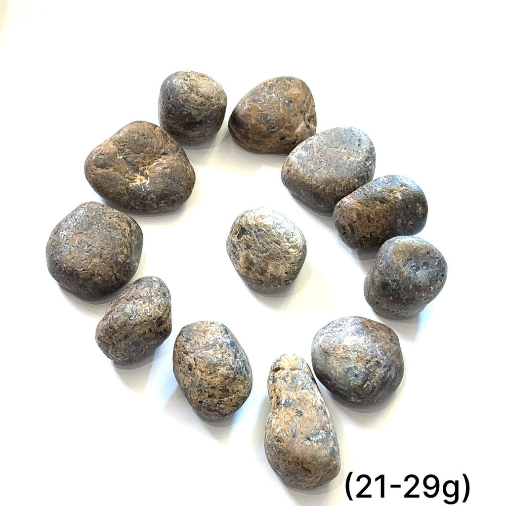 Assorted Golden Sapphire stones showing golden reflections and rich brown tones representing prosperity and determination grouping of (21-29g) on white overview