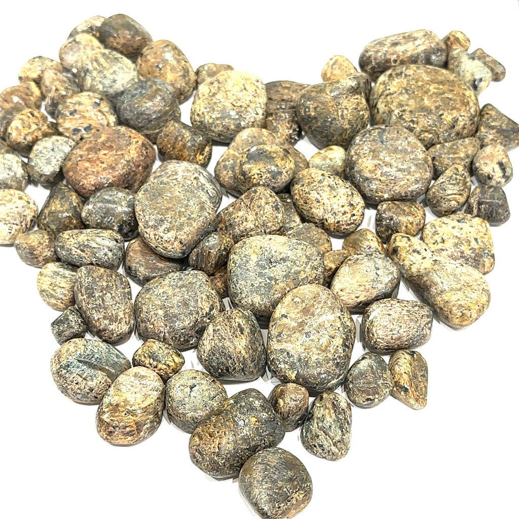 Assorted Golden Sapphire stones showing golden reflections and rich brown tones representing prosperity and determination on white overview