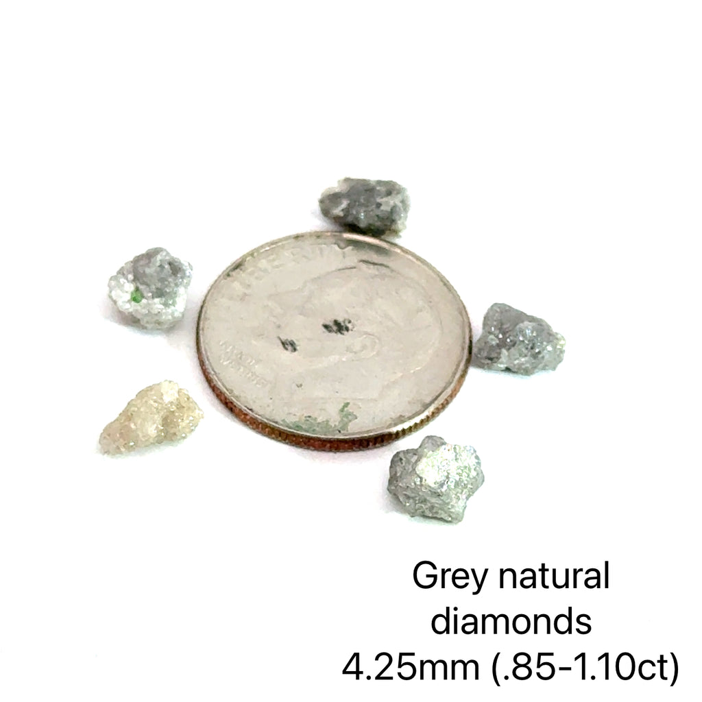 Assorted raw diamonds in perky boxes, representing purity and light. (gray natural diamond 4.25mm .85- 1.10ct) on white front view