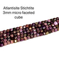 Atlantisite Stichtite 3mm micro-faceted cube gemstone strand on a white background, overview. 
