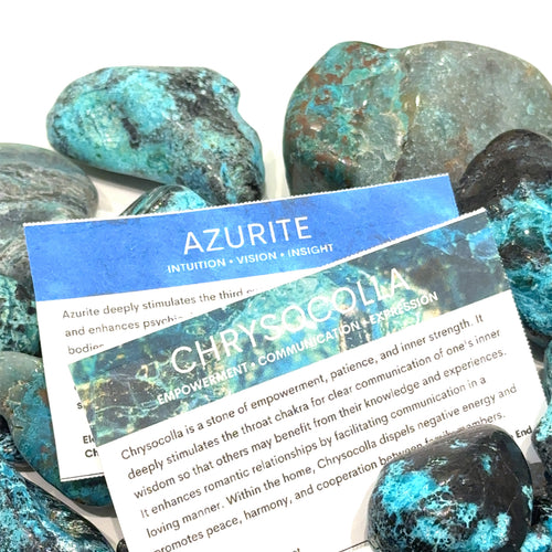 Azurite / Chrysocolla gemstone with Hidden Jewel of the South End information card and purple-silver packaging on white close up view