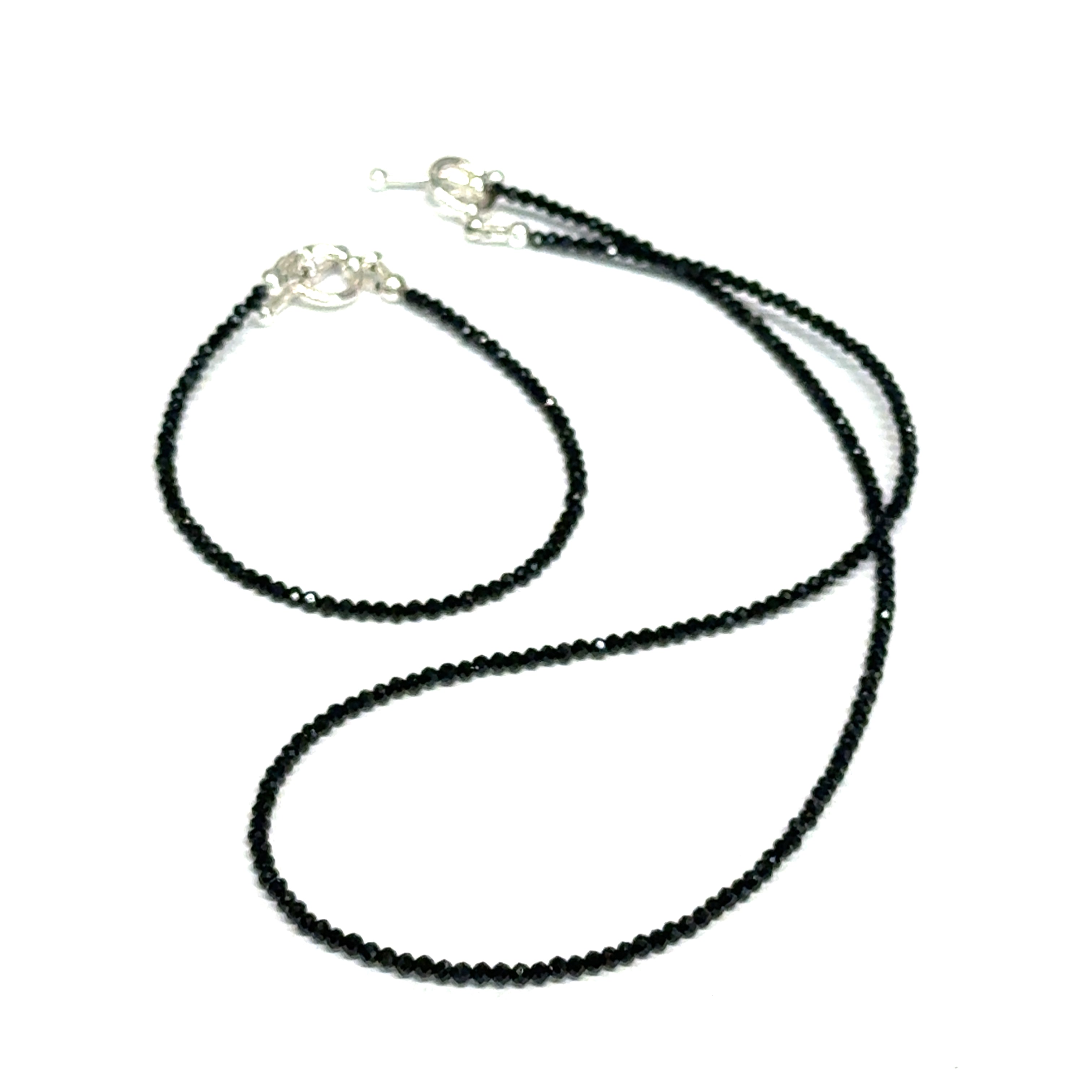 Black Spinel gemstone necklace & it's matching bracelet, both with a sterling silver toggle clasp, genuine gemstone-quality beads, strength and renewal jewelry, on a white background, front overview. 