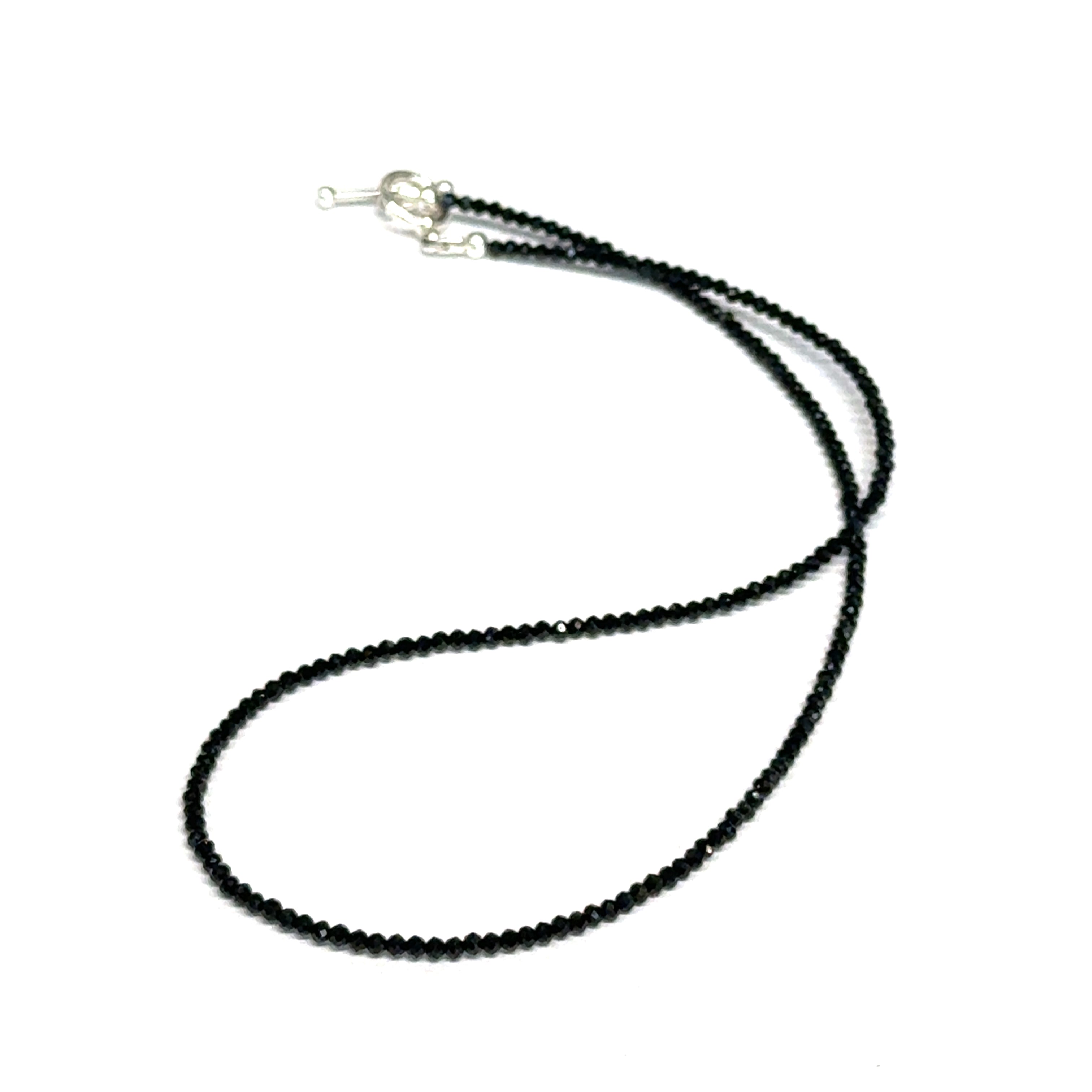 Black Spinel gemstone necklace with a sterling silver toggle clasp, genuine gemstone-quality beads, strength and renewal jewelry, on a white background, front overview. 