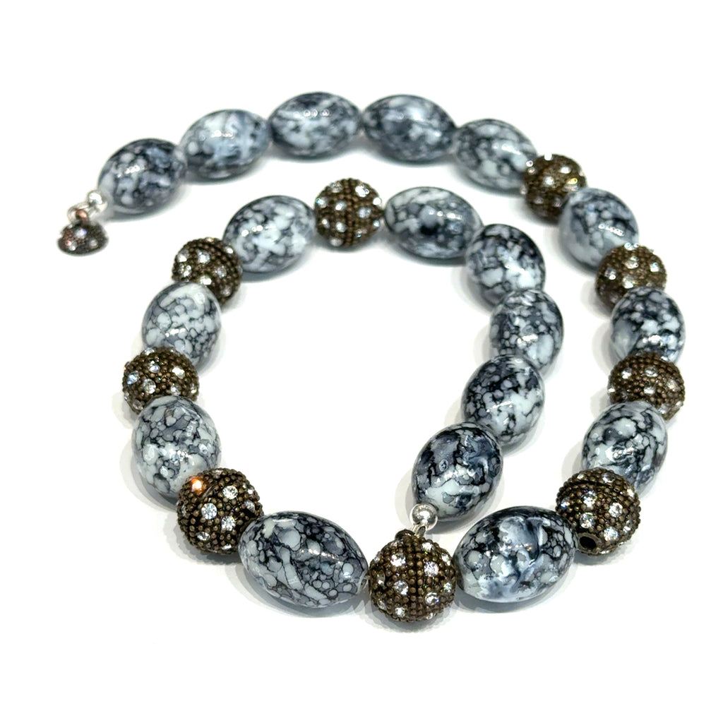 Black & White Marbled Beaded Necklace on white spiral top overview