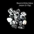 Black and white zebra jasper stones on a black background with text indicating weight range (0-0g), front overview.