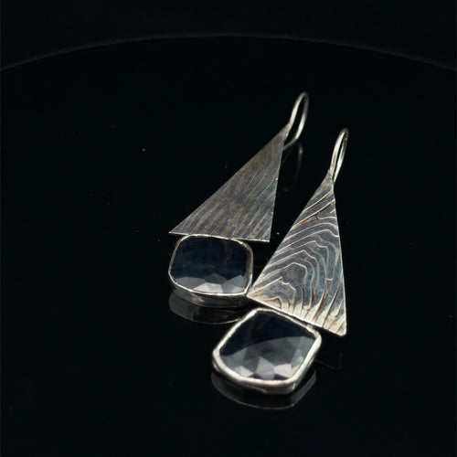 Blue Sapphire & Sterling Silver Triangle Drop Earrings on black canter view