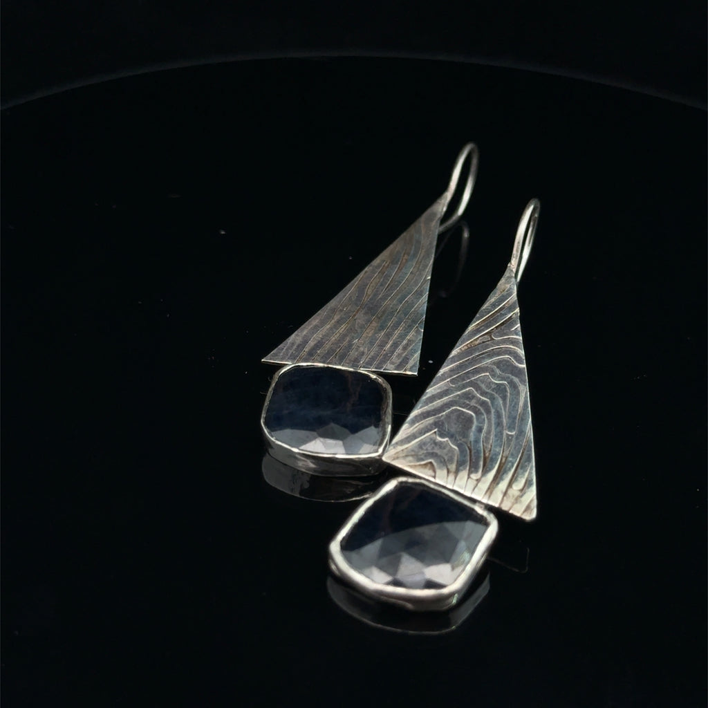 Blue Sapphire & Sterling Silver Triangle Drop Earrings on black canter view