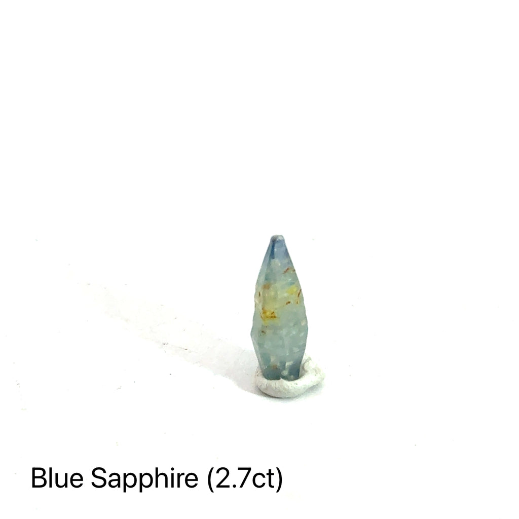 Blue Sapphire raw gemstone on white 2.7ct front view