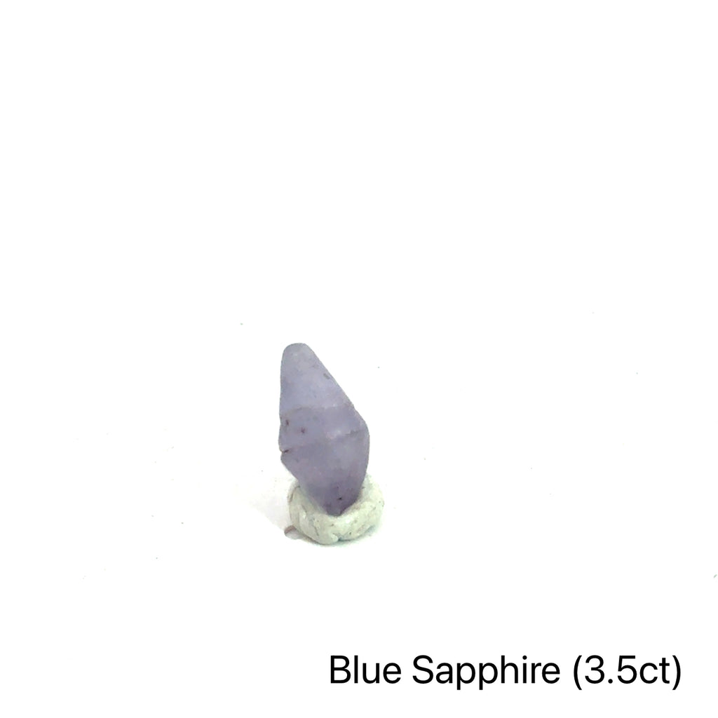 Blue Sapphire raw gemstone on white 3.5ct front view