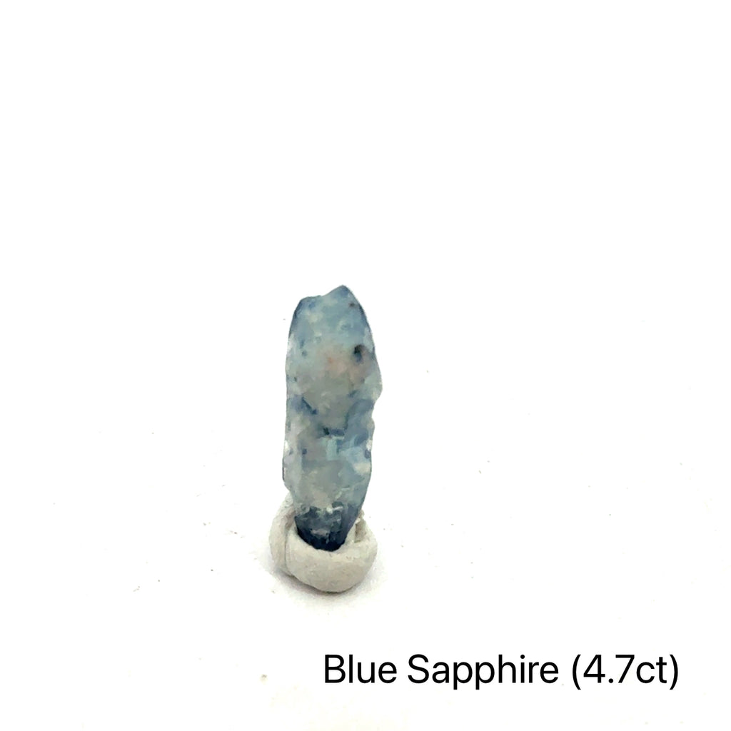 Blue Sapphire raw gemstone on white 4,7ct front view
