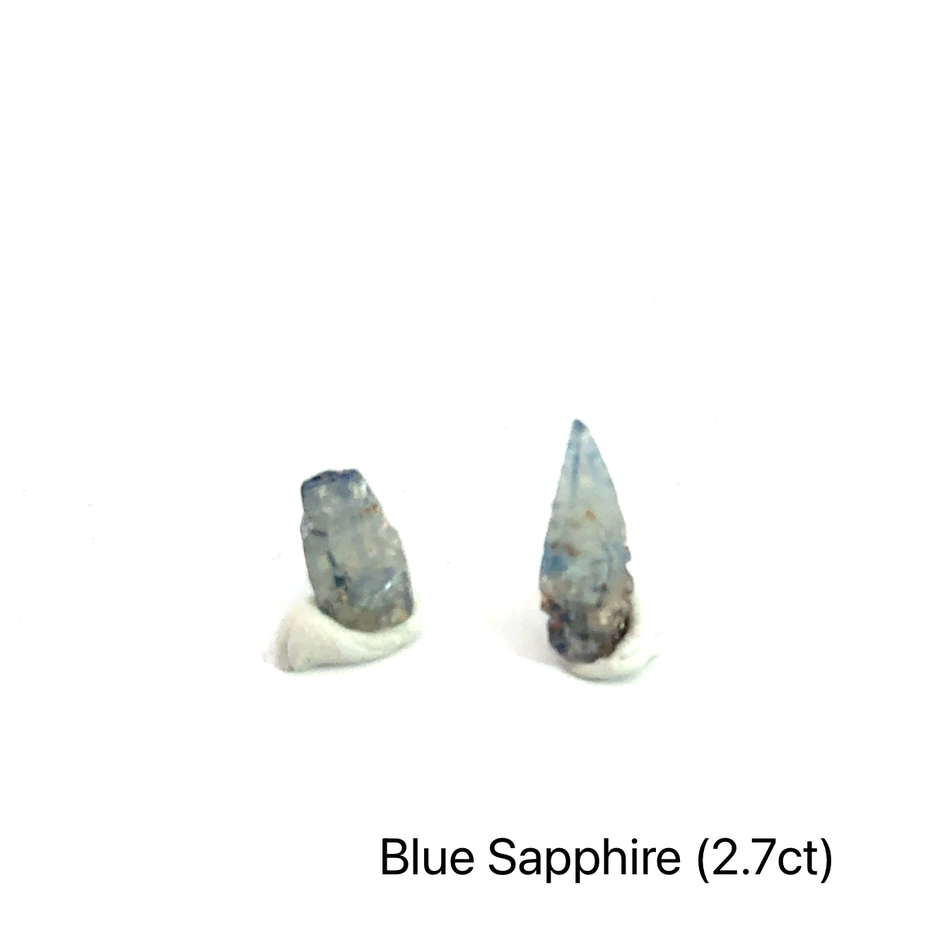 Blue Sapphire raw gemstone on white grouping 2.7ct front view
