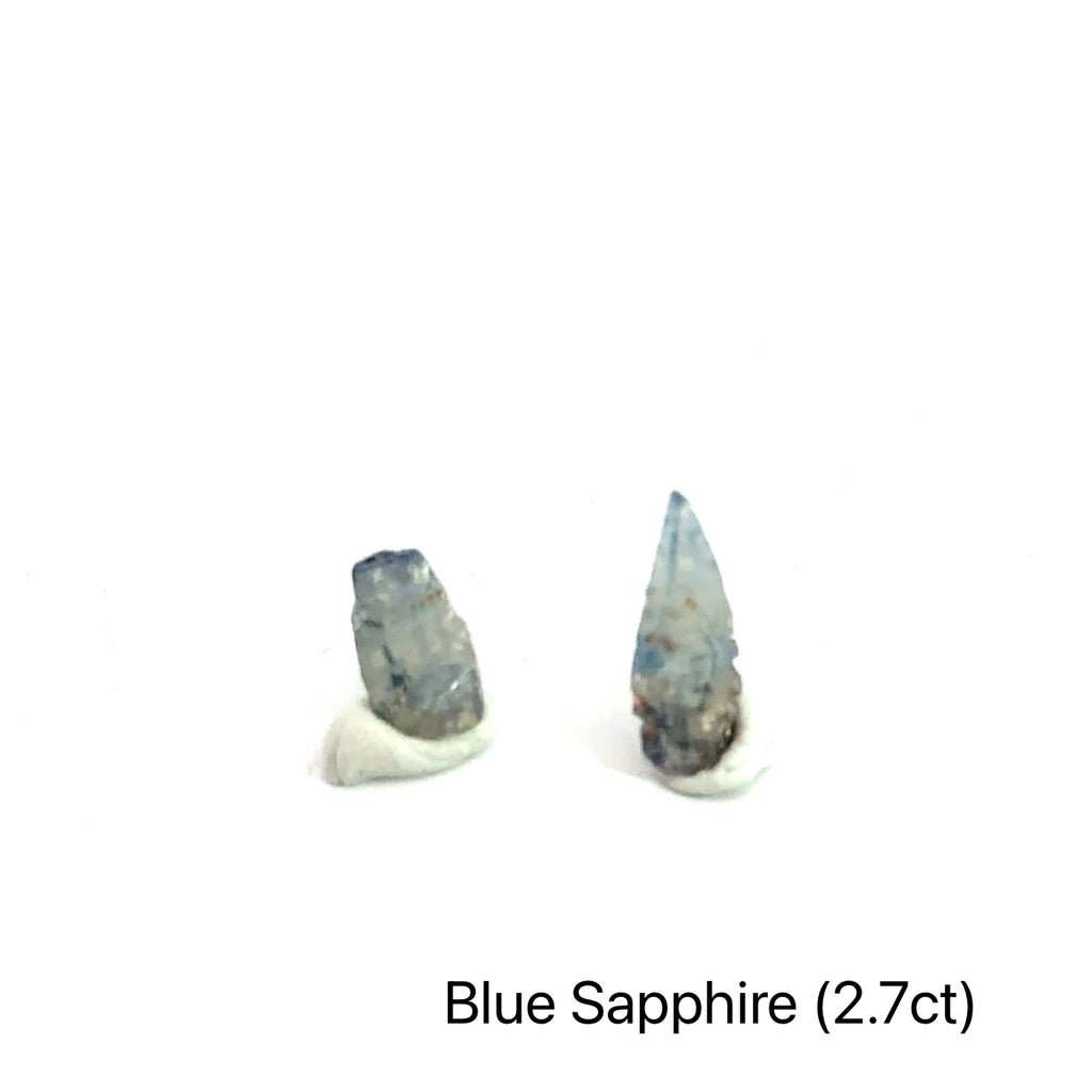 Blue Sapphire raw gemstone on white grouping 2.7ct front view