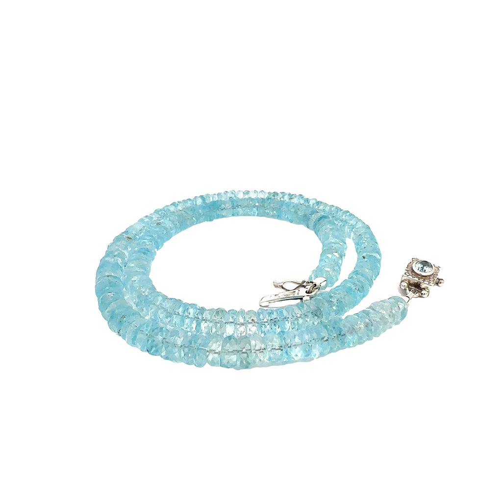 Blue Topaz Gemstone Necklace  on white left side close up spiral  view