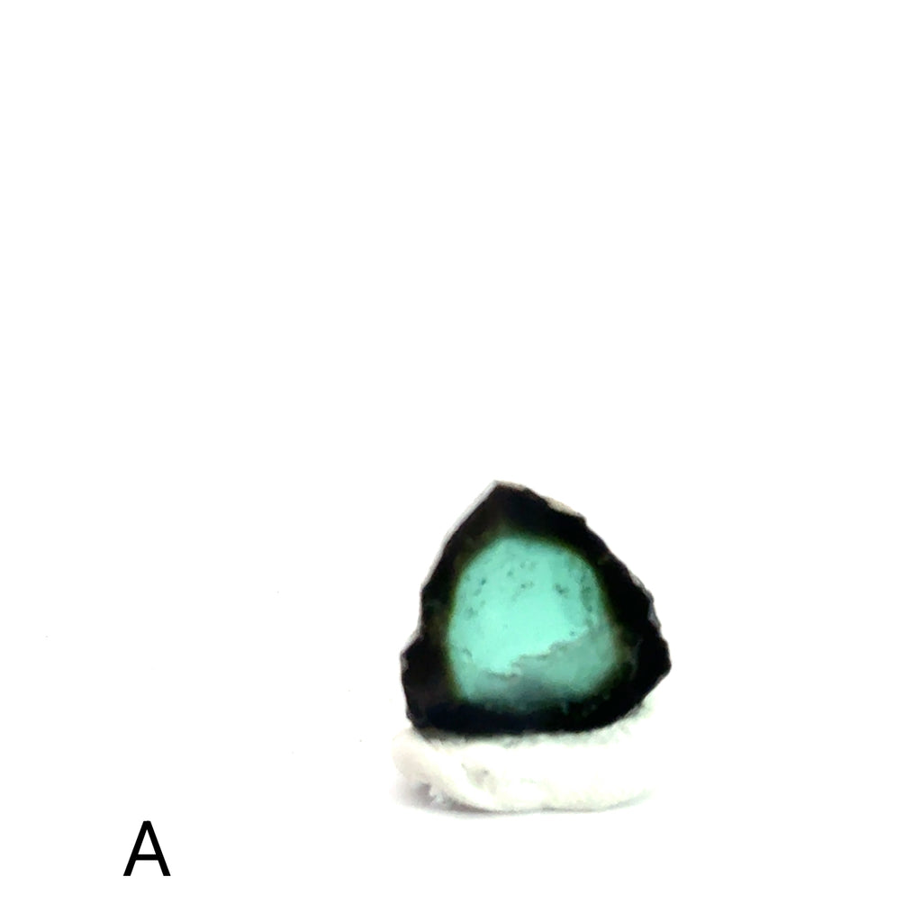 Blue Tourmaline Raw Gemstone Slice on white  A on front view