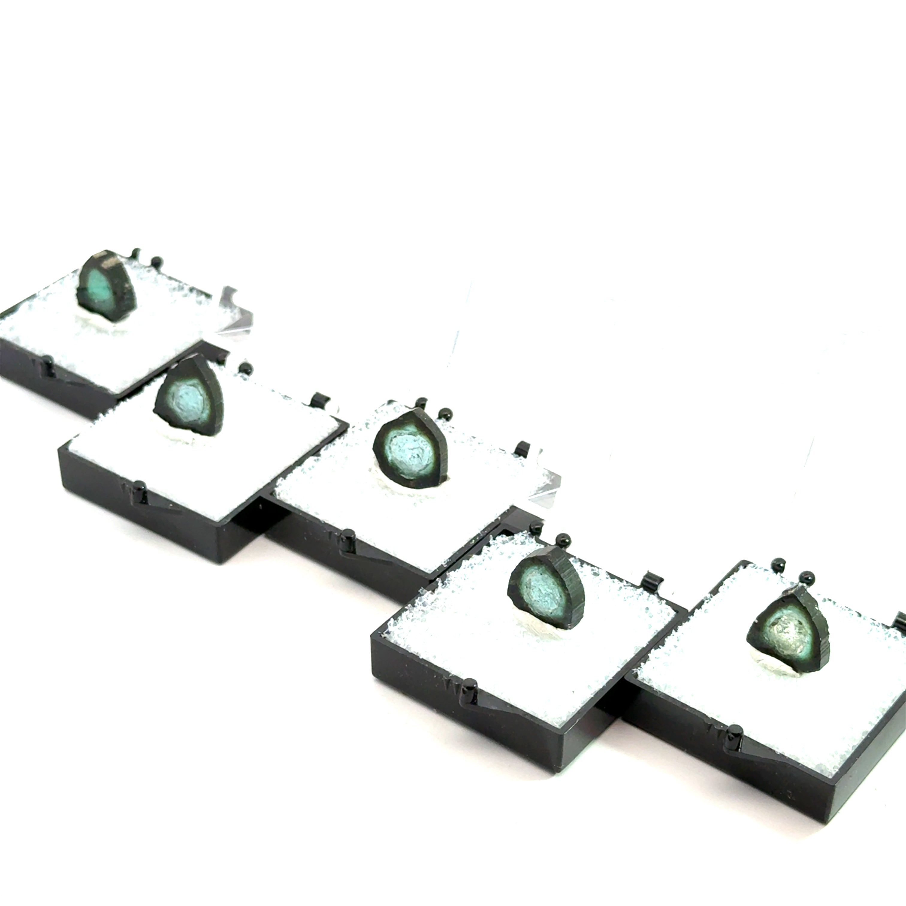 Blue Tourmaline Raw Gemstone Slice on white grouping in perky boxes on front view