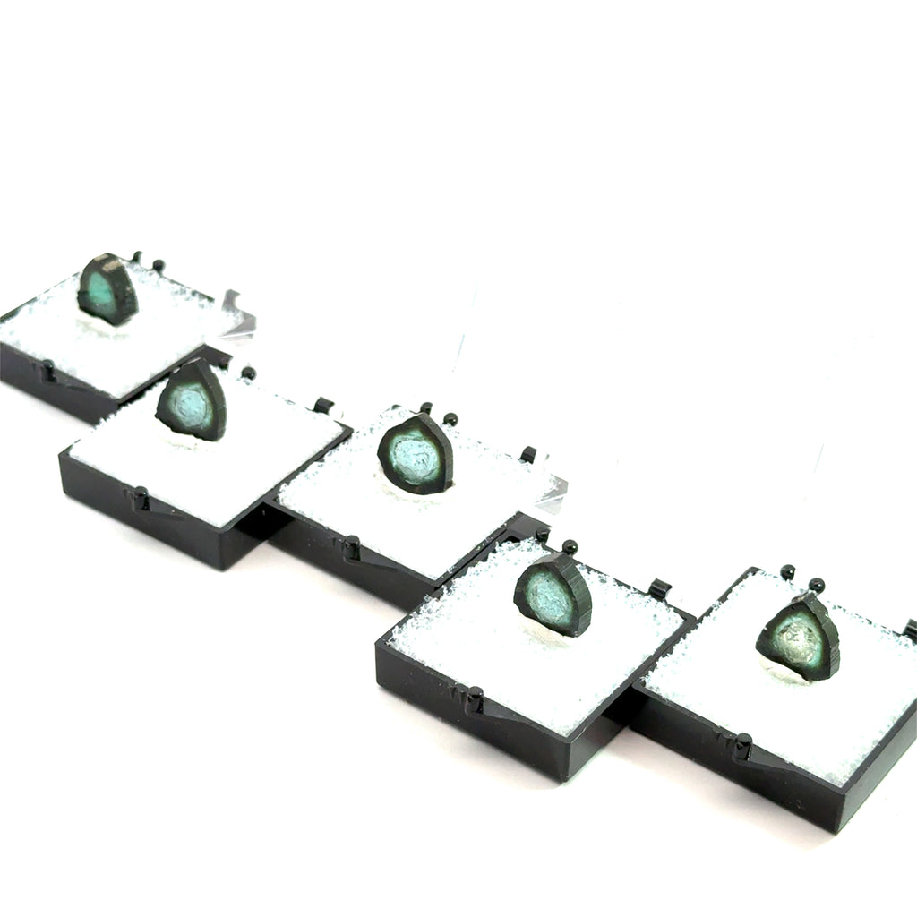 Blue Tourmaline Raw Gemstone Slice on white grouping in perky boxes on front view