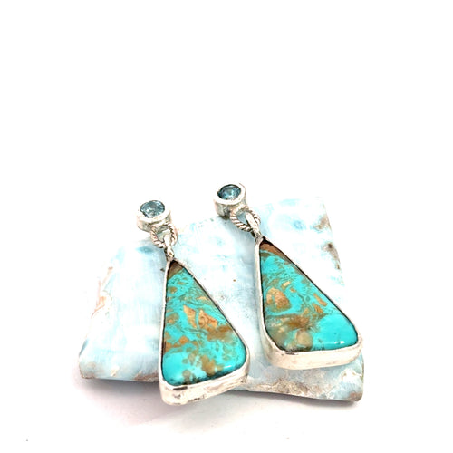 Blue Zircon and Royston Turquoise sterling silver drop earrings — handcrafted by Hidden Jewel South End on a white background lifted by a gemstone front slight angled right. 