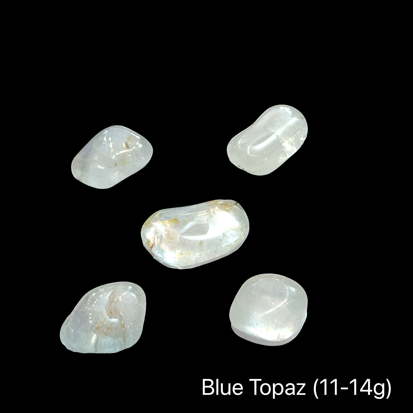 Blue topaz stones, 11-14g each, on a black background, front view.