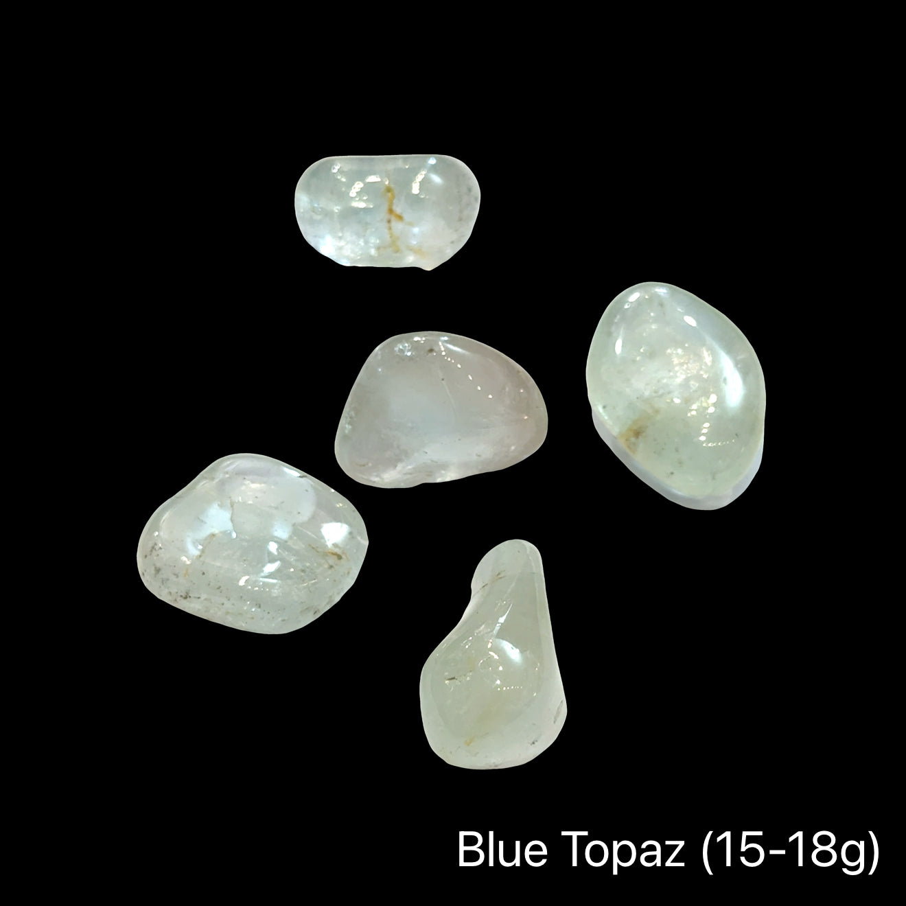 Blue topaz stones, 15-18g each, on a black background, front view.