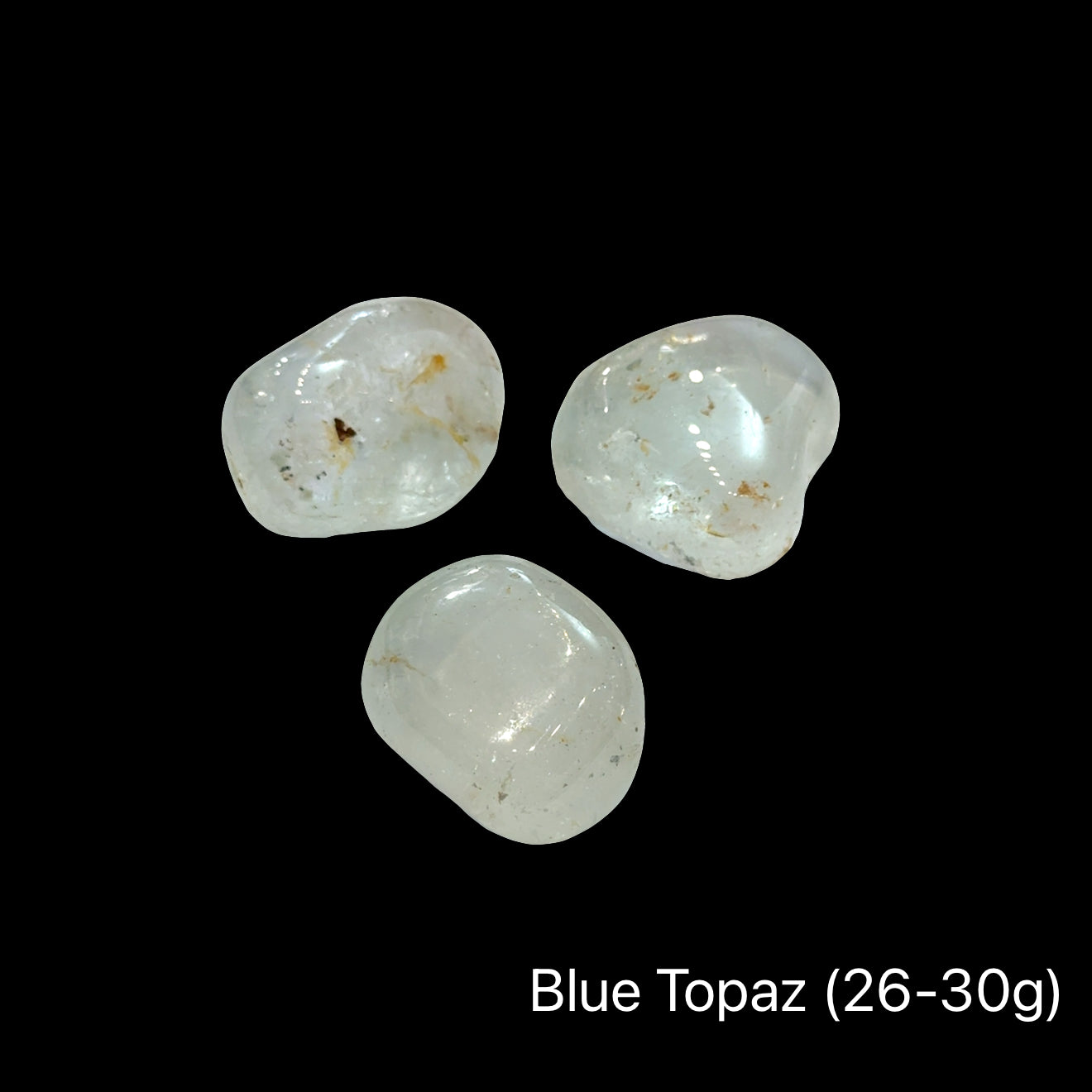 Blue topaz stones, 26-30g each, on a black background, front view.