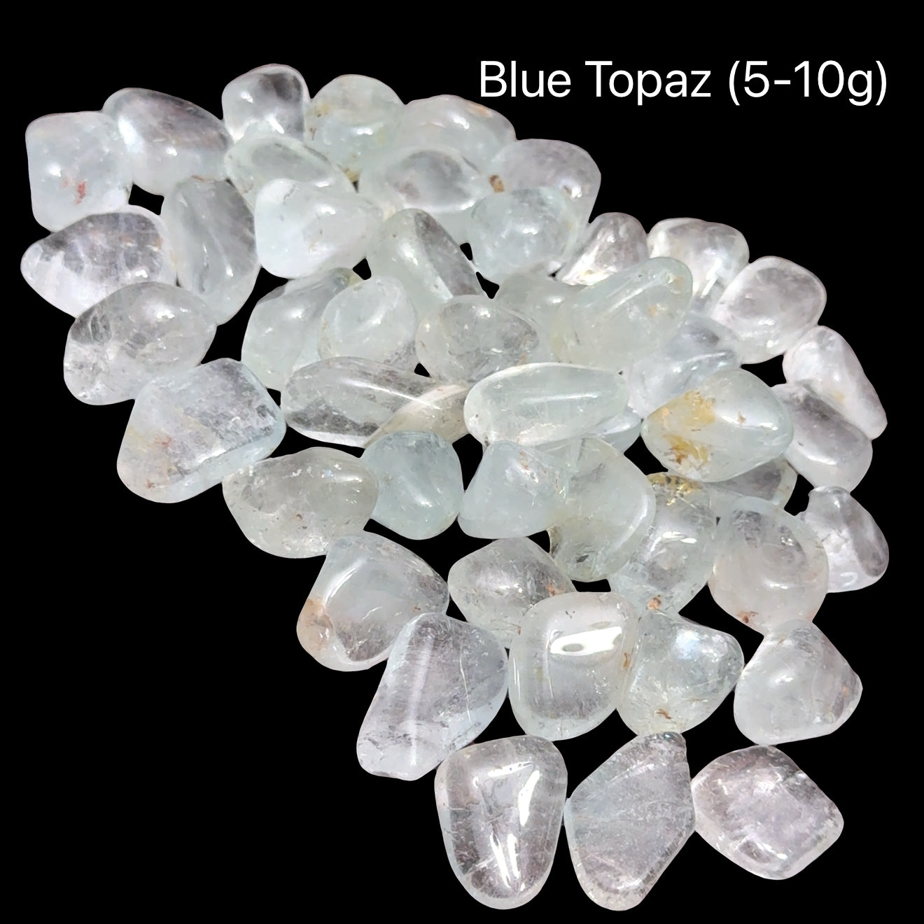 Blue topaz stones, 5-10g each, on a black background, front view.