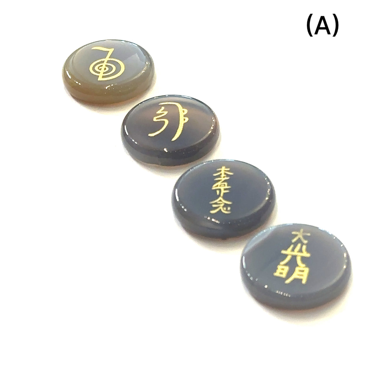 Botswana Agate Reiki 4-piece gemstone set with gold-etched Usui Reiki symbols displayed on white background set A front view. 