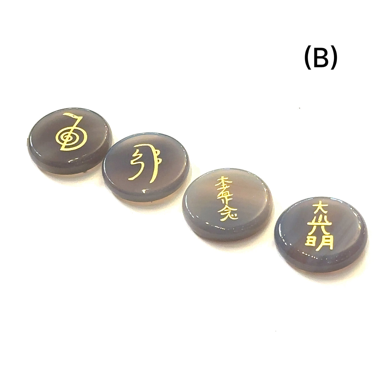 Botswana Agate Reiki 4-piece gemstone set with gold-etched Usui Reiki symbols displayed on white background set B front view. 