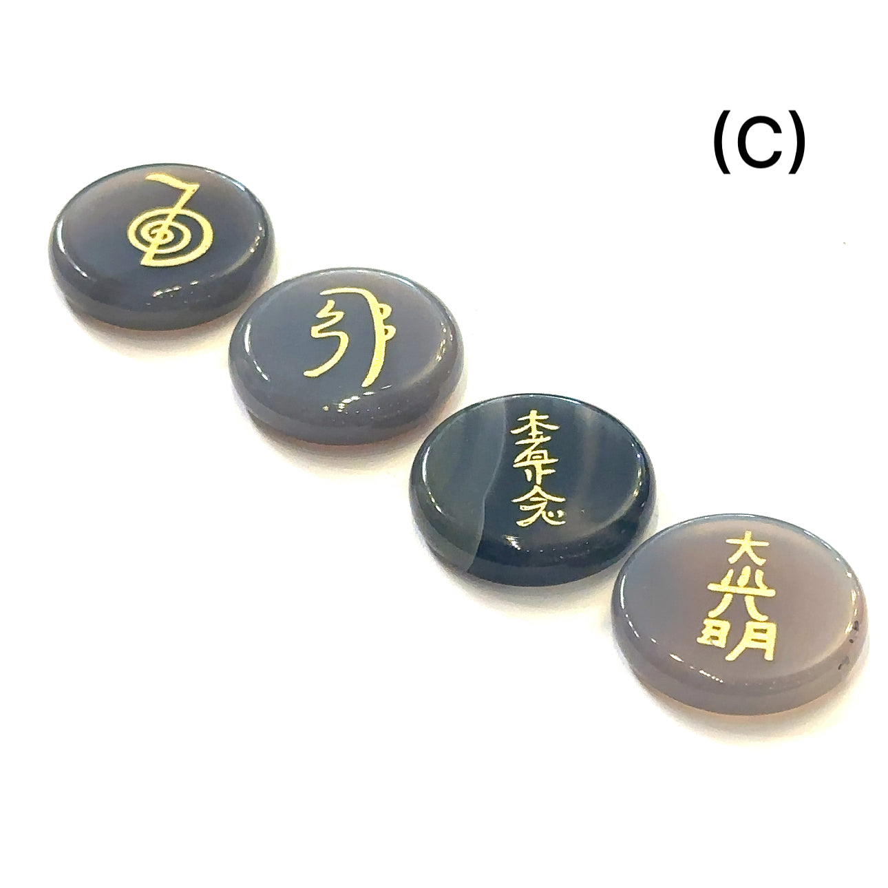 Botswana Agate Reiki 4-piece gemstone set with gold-etched Usui Reiki symbols displayed on white background set C front view. 