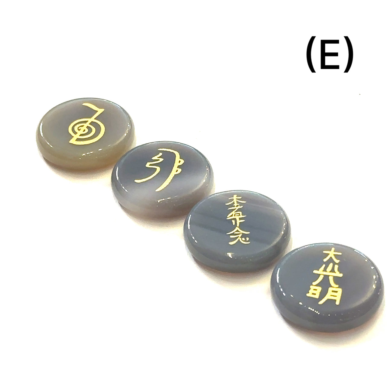Botswana Agate Reiki 4-piece gemstone set with gold-etched Usui Reiki symbols displayed on white background set E front view. 